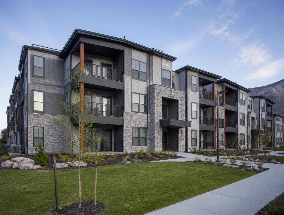 Recently completed three-story apartment building with stone and fiber cement facade